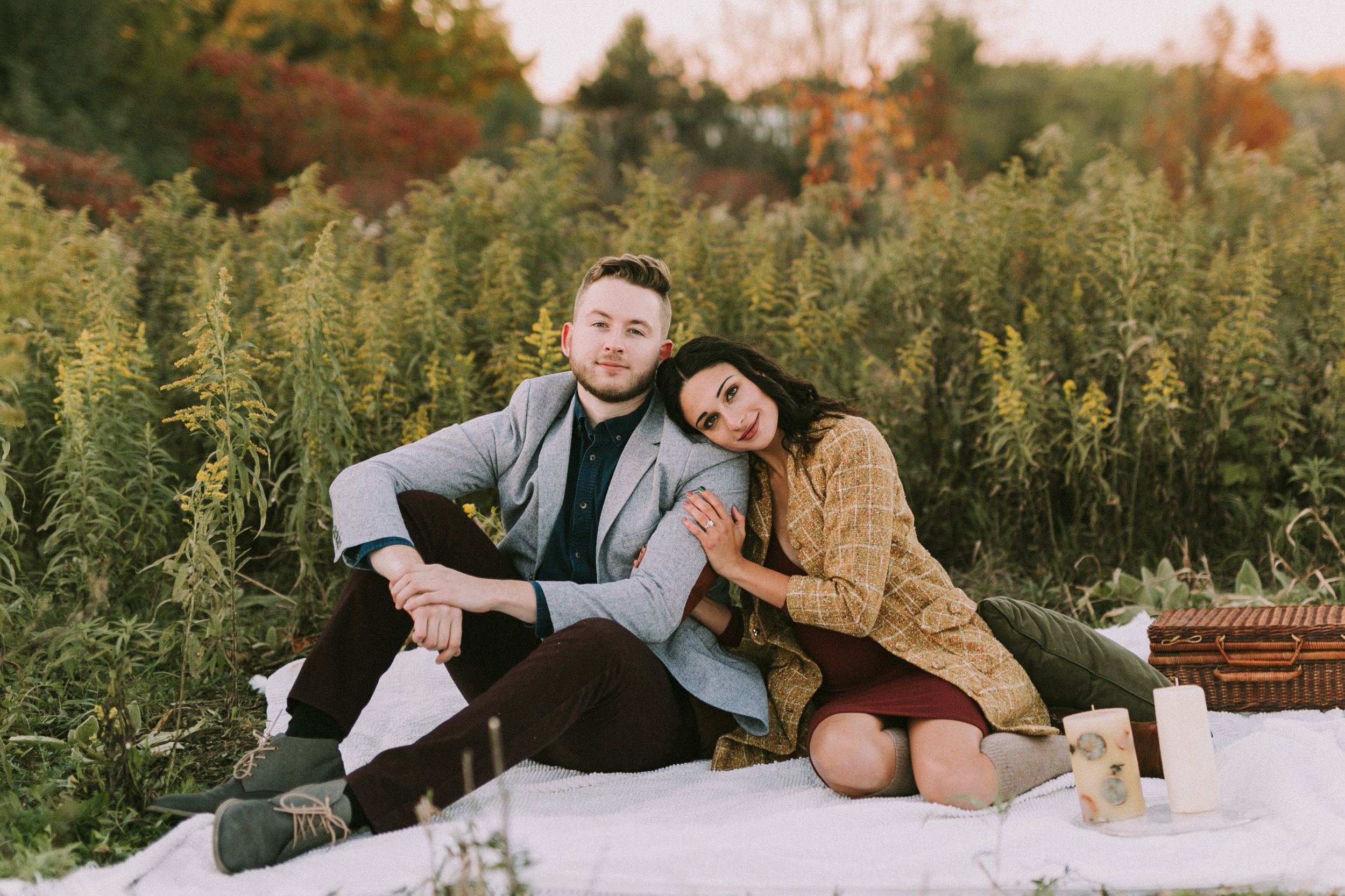 Huron Natural Area Kitchener Fall Engagement A couple posing near a tree during their fall engagement session at Huron Natural Area in Kitchener